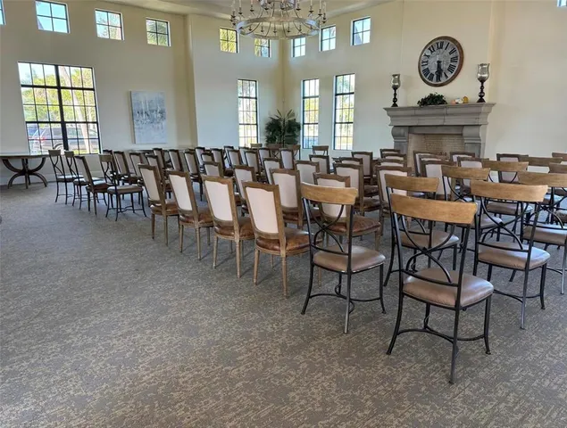 a front view of multi story residential apartment building with yard and sign board
