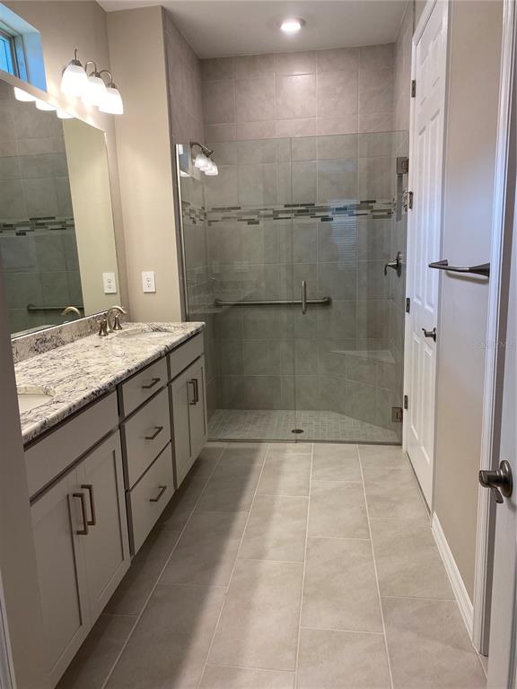 124 Soliera Street Nokomis, FL 34275 - Photo 7 of 43 a bathroom with a granite countertop sink a toilet a mirror and shower