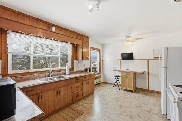 a large kitchen with a lot of cabinets and refrigerator