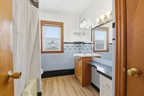 a bathroom with a sink a mirror and a shower