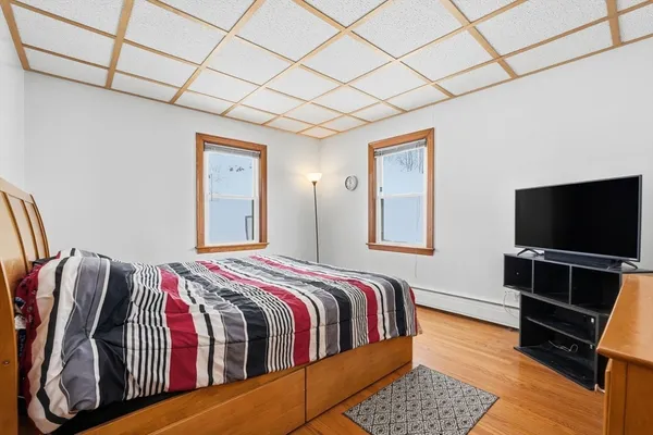 a bedroom with a bed and a flat screen tv