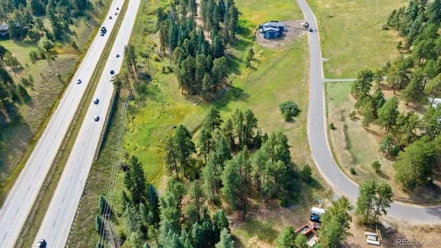 a view of a pool with a table and chairs