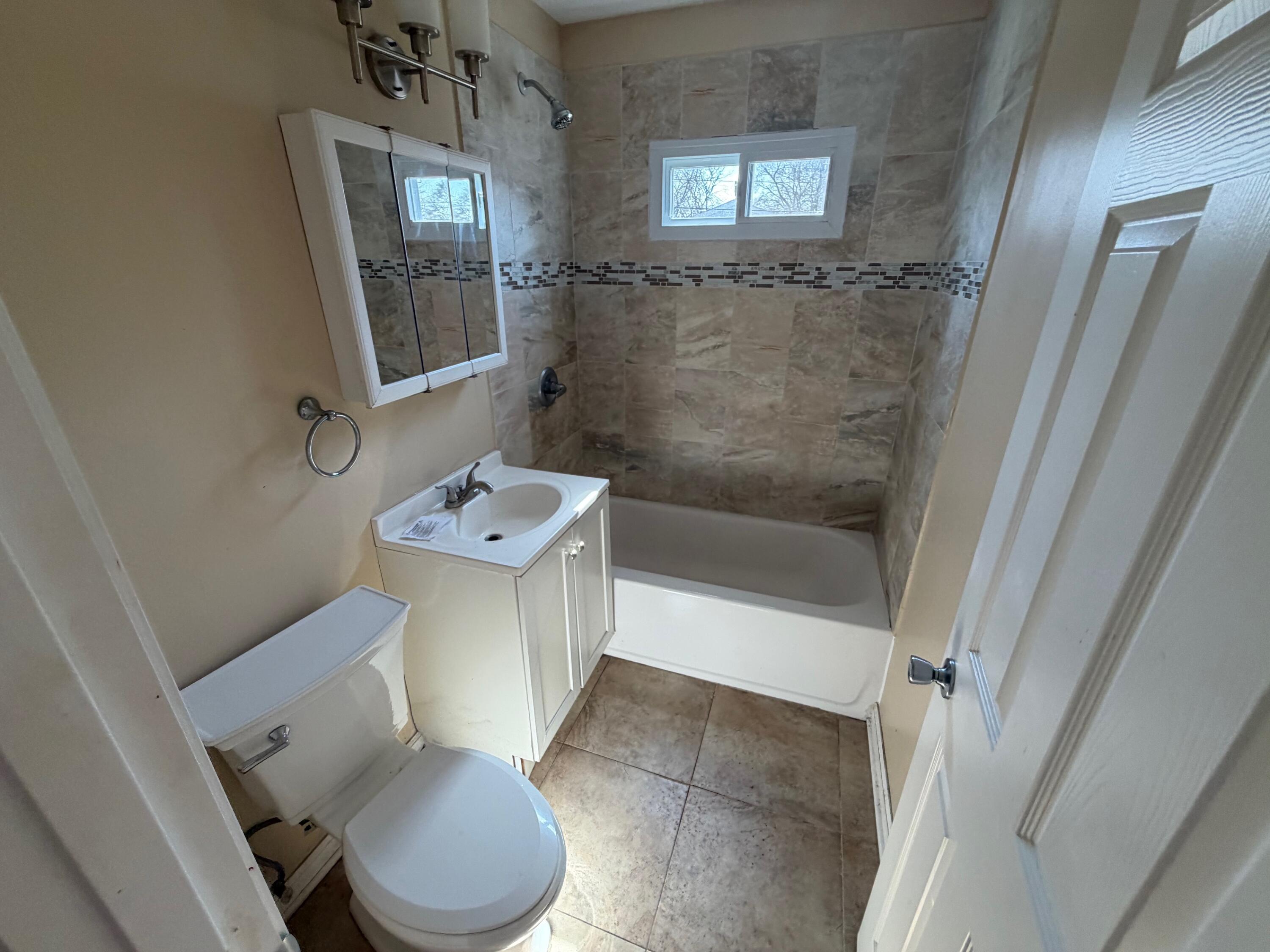 4247 West 19th Place Gary, IN 46404 - Photo 5 of 9 a bathroom with a sink a toilet and shower
