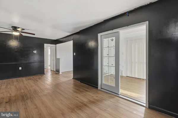 a view of an empty room and wooden floor