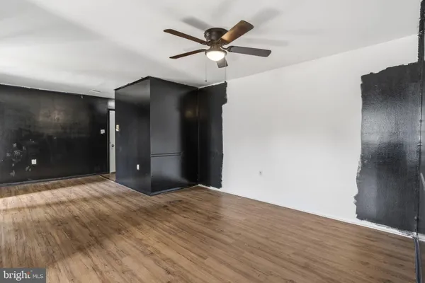a view of an empty room with a ceiling fan