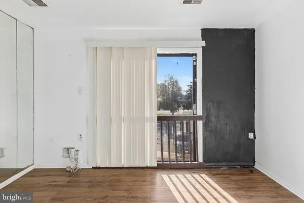 a view of a bathroom with wooden floor and a window