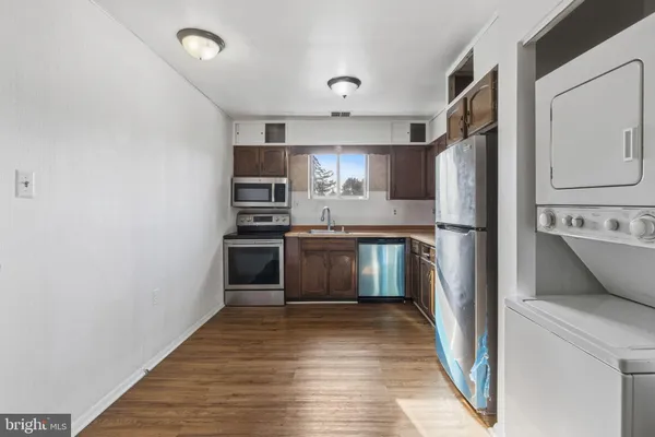 a kitchen with stainless steel appliances a refrigerator and a stove top oven