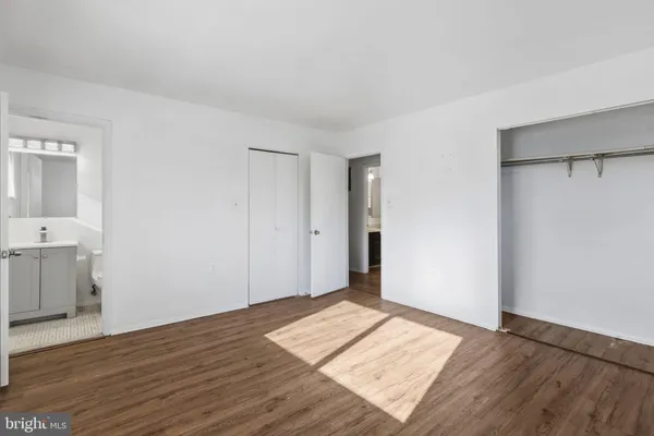 a view of a room with wooden floor and white walls