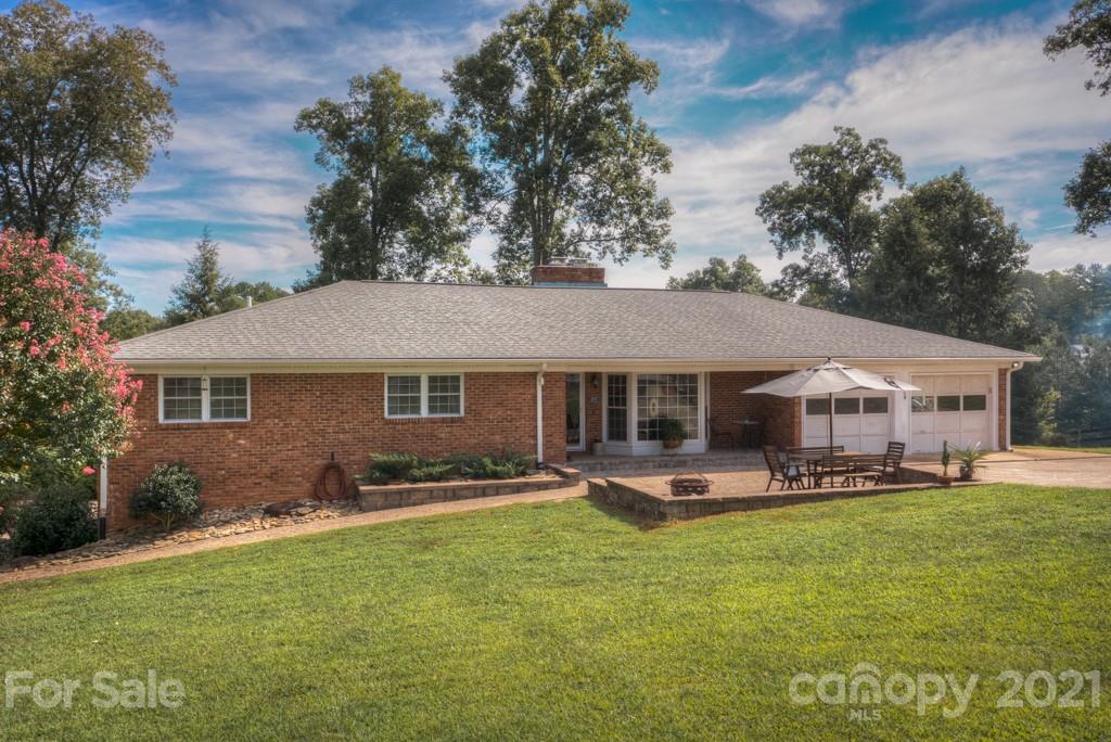 2667 Bill Collins Road Tryon, NC 28782 - Photo 17 of 48 a front view of a house with a yard patio and fire pit