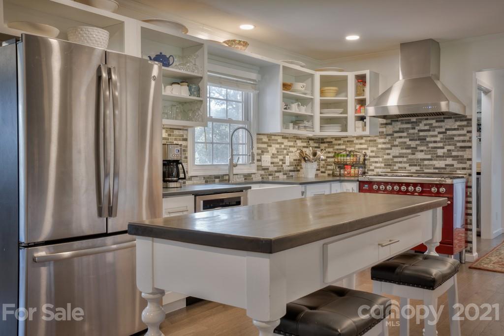 2667 Bill Collins Road Tryon, NC 28782 - Photo 27 of 48 a kitchen with stainless steel appliances granite countertop a refrigerator and a stove