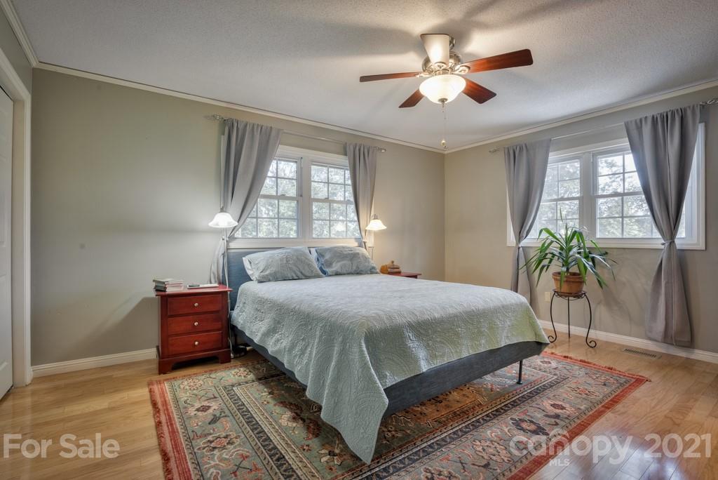 2667 Bill Collins Road Tryon, NC 28782 - Photo 35 of 48 a bedroom with a bed and a potted plant