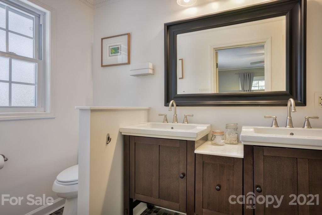 2667 Bill Collins Road Tryon, NC 28782 - Photo 36 of 48 a bathroom with a toilet sink and mirror
