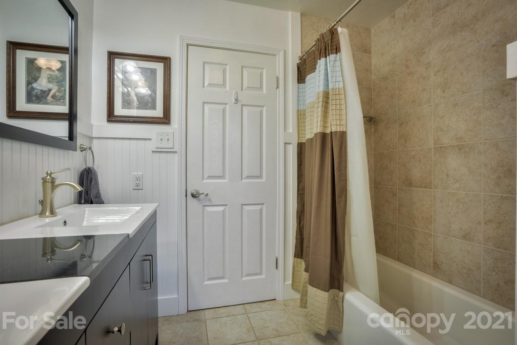 2667 Bill Collins Road Tryon, NC 28782 - Photo 40 of 48 a bathroom with a granite countertop sink a toilet and shower
