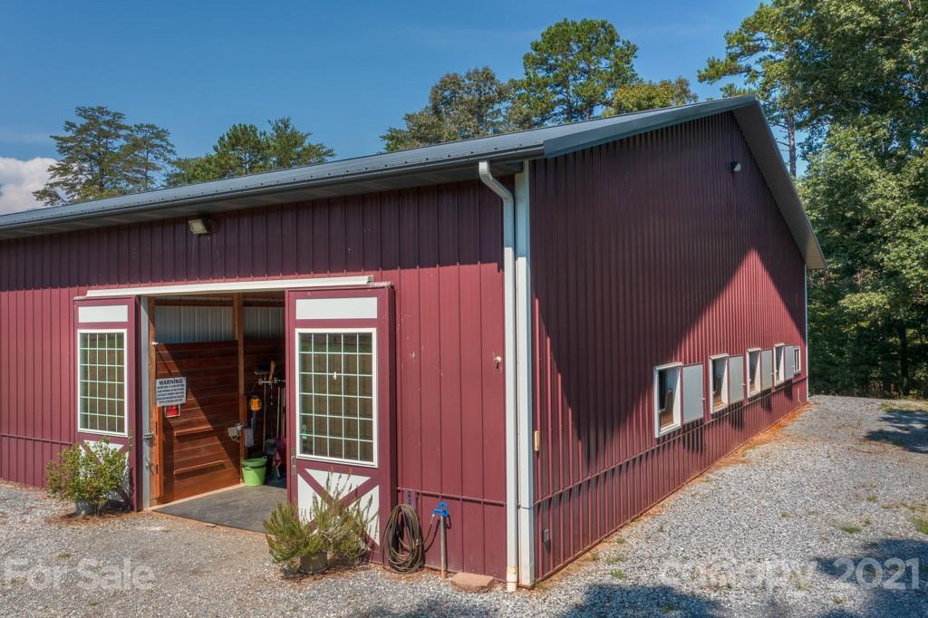2667 Bill Collins Road Tryon, NC 28782 - Photo 5 of 48 a front view of a house with garden