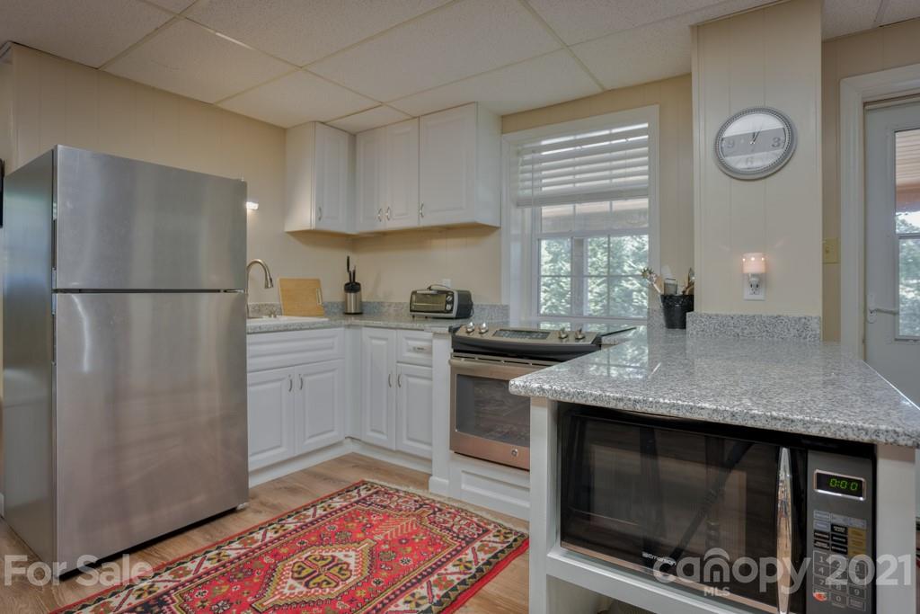 2667 Bill Collins Road Tryon, NC 28782 - Photo 45 of 48 a kitchen with stainless steel appliances granite countertop a stove a sink and a refrigerator
