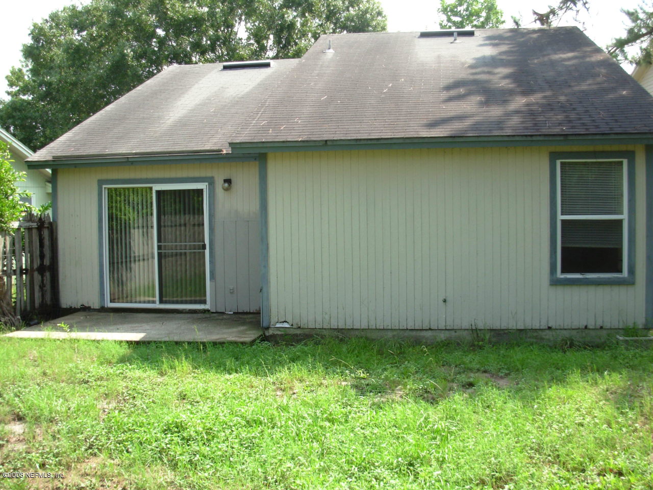 2440 Spring Vale Road Jacksonville, FL 32246 - Photo 7 of 7 a view of a backyard with potted plants and a large tree