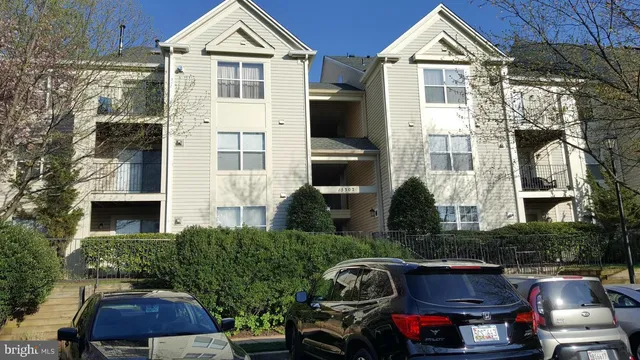 a front view of a house with garage and plants