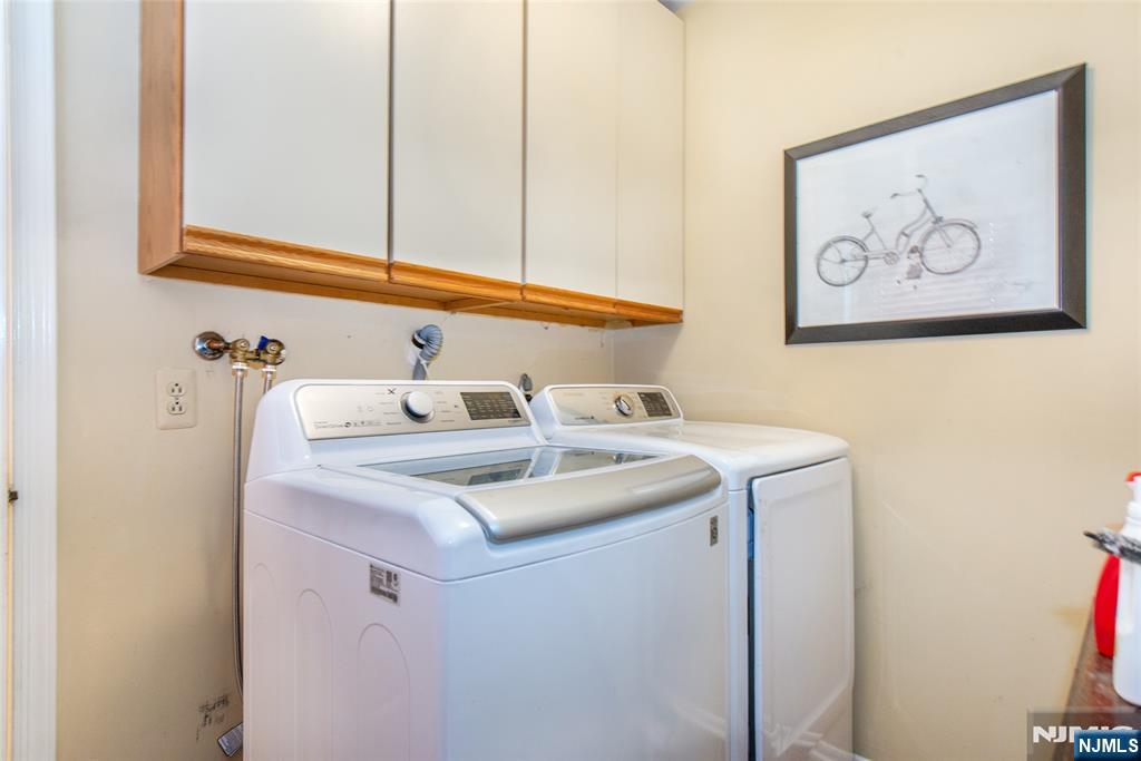 8 Tomahawk Drive Wayne, NJ 07470 - Photo 14 of 35 a bathroom with a sink and a white cabinet