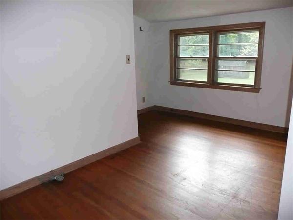 558 Leadmine Road Sturbridge, MA 01566 - Photo 13 of 15 an empty room with wooden floor and windows