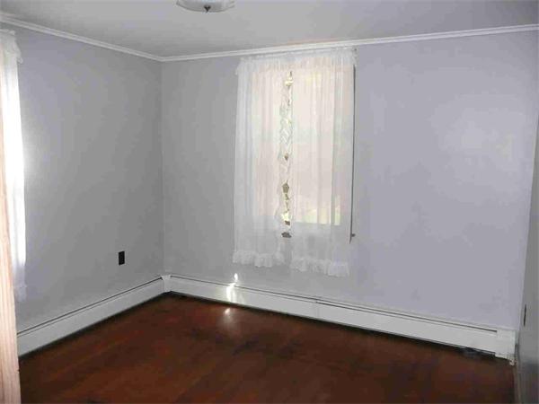 558 Leadmine Road Sturbridge, MA 01566 - Photo 10 of 15 an empty room with wooden floor