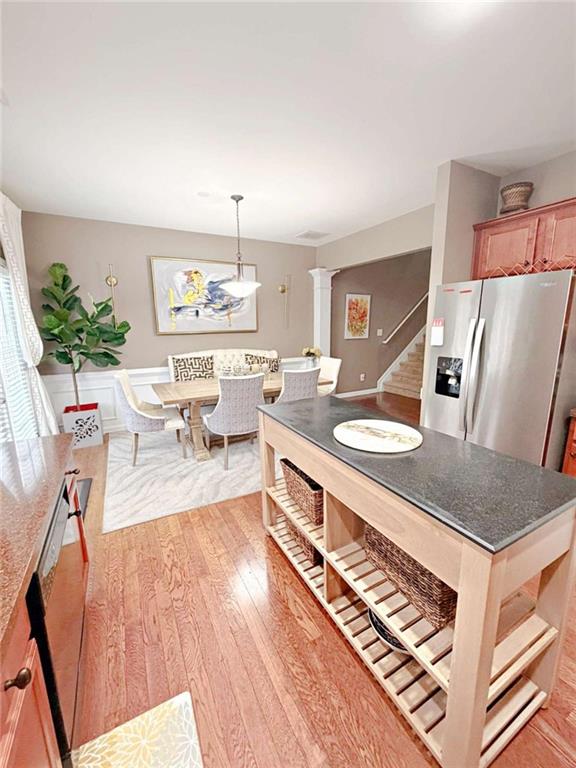 2708 Beynon Lane Northeast Suwanee, GA 30024 - Photo 13 of 38 a very nice looking dining room with kitchen island a stove a table and chairs
