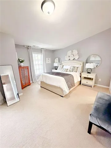 a spacious bedroom with a bed and window