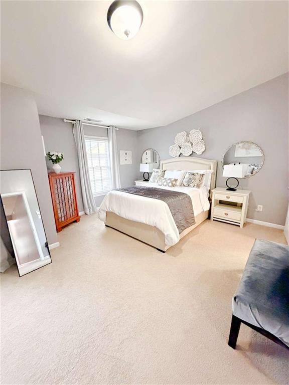 2708 Beynon Lane Northeast Suwanee, GA 30024 - Photo 15 of 38 a spacious bedroom with a bed and window