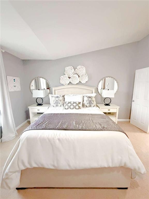 2708 Beynon Lane Northeast Suwanee, GA 30024 - Photo 16 of 38 a spacious bedroom with a bed and mirror