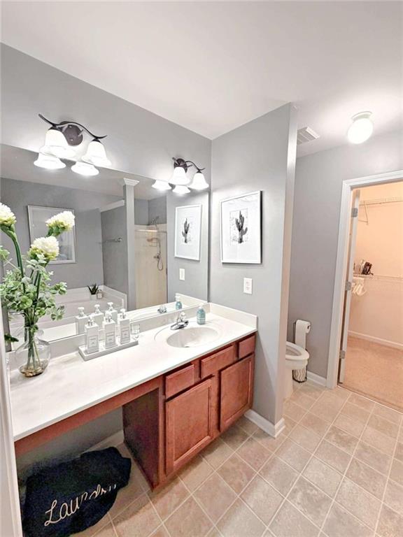 2708 Beynon Lane Northeast Suwanee, GA 30024 - Photo 18 of 38 a bathroom with a sink a toilet and mirror
