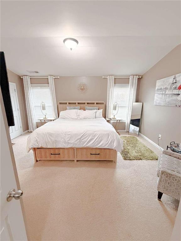 2708 Beynon Lane Northeast Suwanee, GA 30024 - Photo 23 of 38 a bedroom with a bed and a mirror