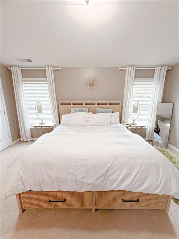 2708 Beynon Lane Northeast Suwanee, GA 30024 - Photo 24 of 38 a bed sitting in a bedroom next to a window