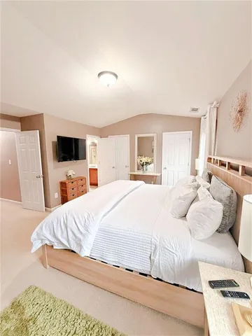 a large white bed in a white room