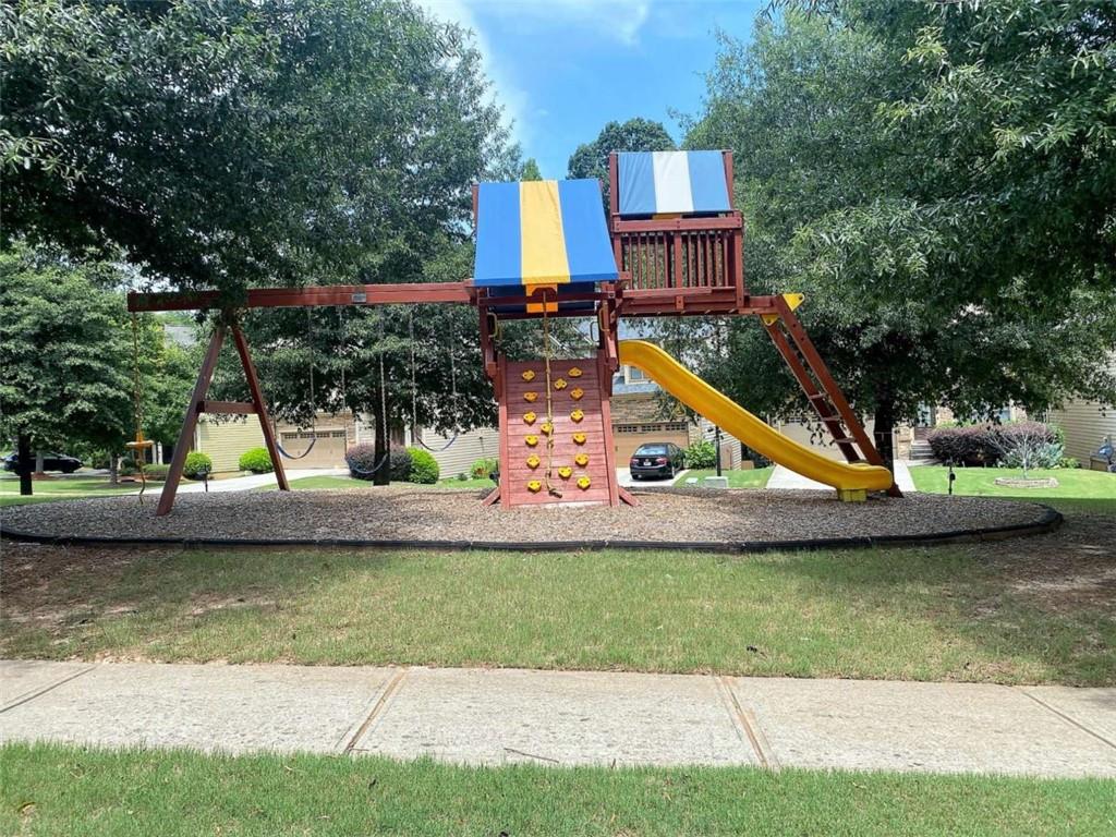 2708 Beynon Lane Northeast Suwanee, GA 30024 - Photo 37 of 38 a view of a house with a yard and sitting area