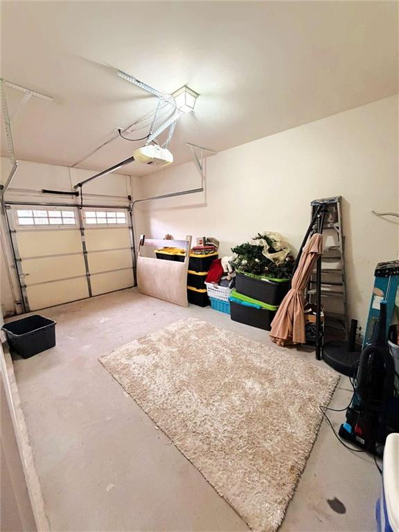 2708 Beynon Lane Northeast Suwanee, GA 30024 - Photo 5 of 38 a bedroom with furniture and a flat screen tv