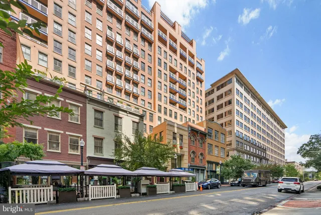 a front view of a building with a yard and seating space