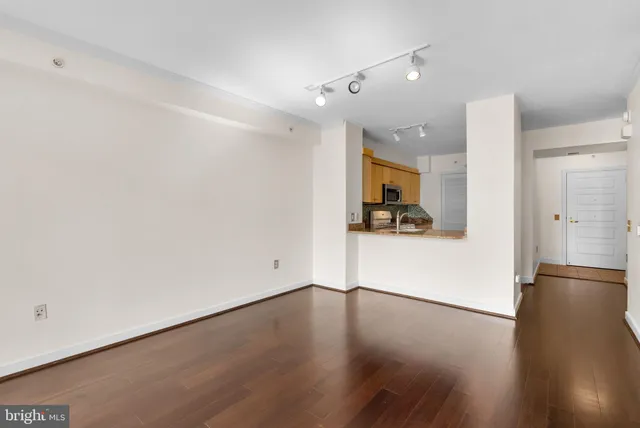 a view of a kitchen with wooden floor and a sink