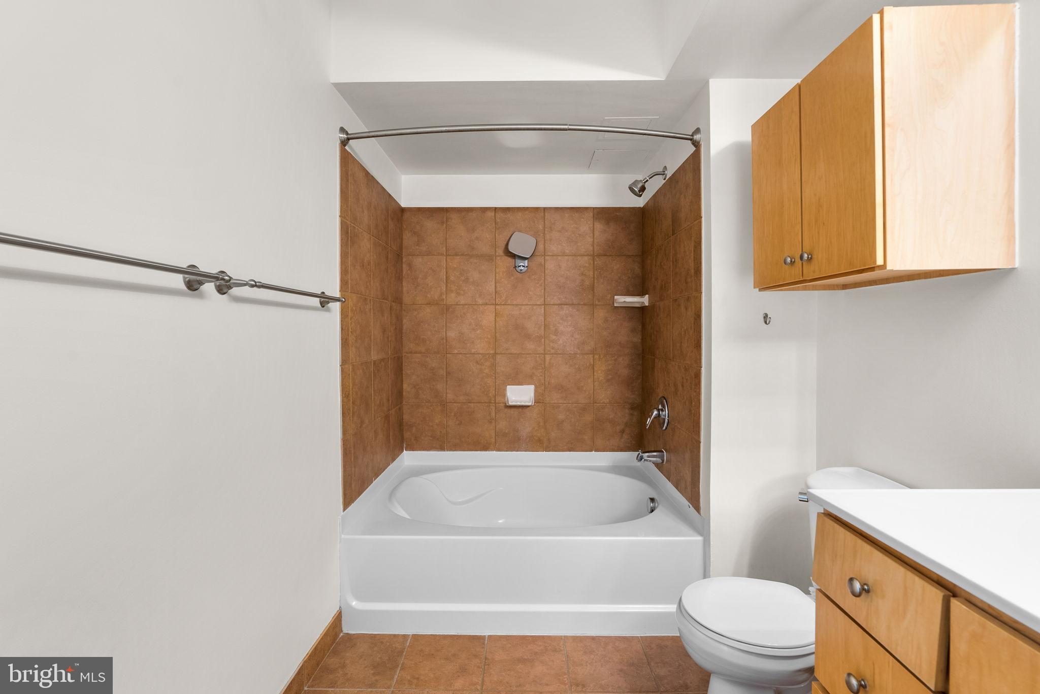 631 D Street Northwest, Unit 1129 Washington, DC 20004 - Photo 26 of 29 a bathroom with a toilet a sink and bathtub