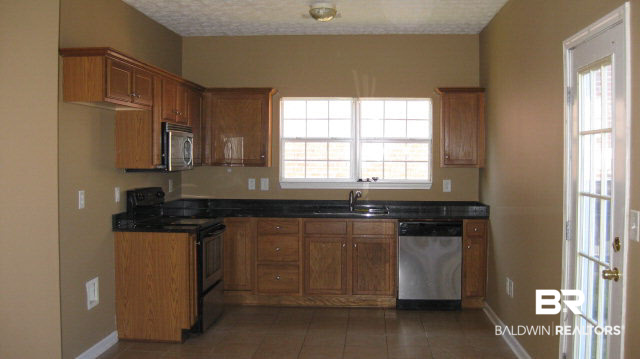 3900 Emerille Drive Foley, AL 36535 - Photo 3 of 6 Comfortable kitchen with dishwasher, microwave, and electric range.