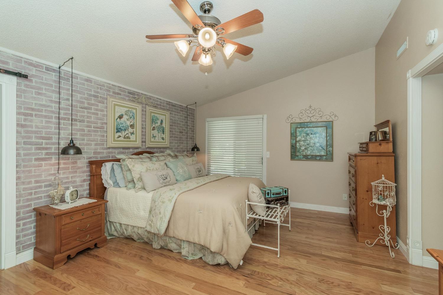 2508 Gibson Avenue Clovis, CA 93611 - Photo 13 of 33 a bedroom with a bed and a chandelier