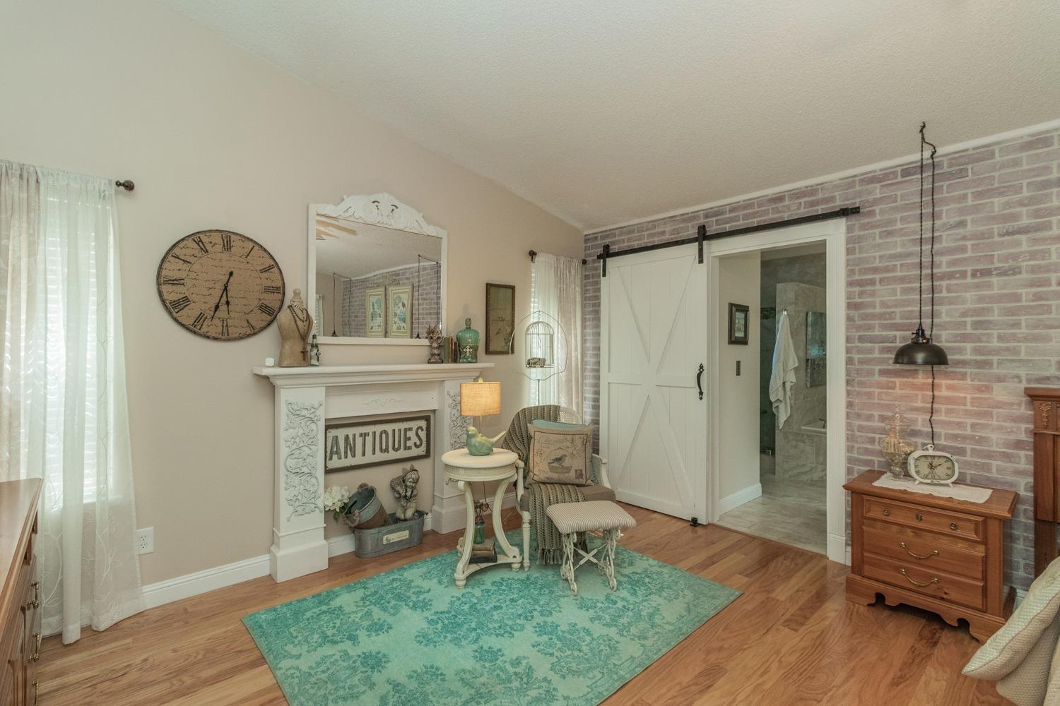 2508 Gibson Avenue Clovis, CA 93611 - Photo 15 of 33 a living room with furniture a table and a clock