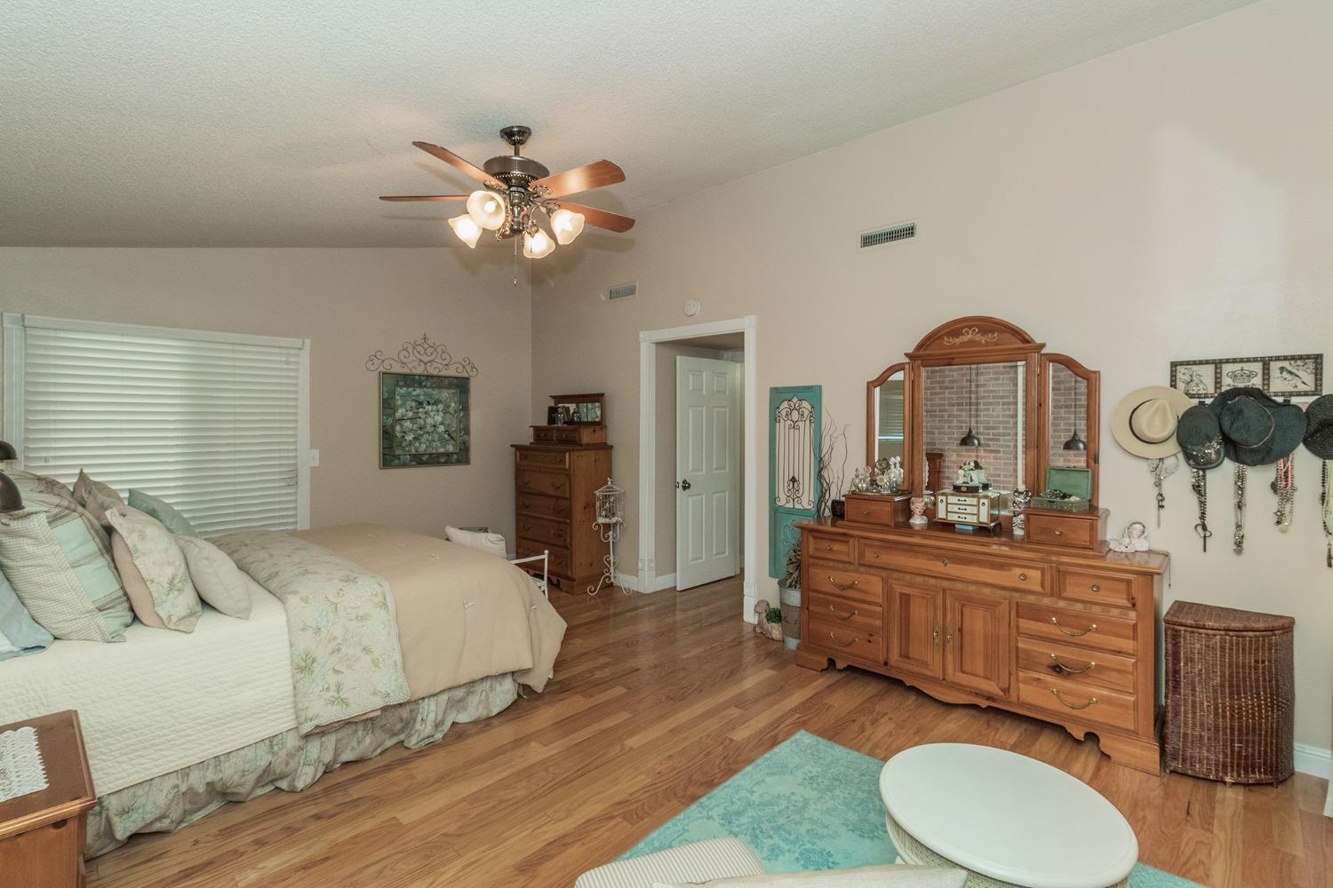 2508 Gibson Avenue Clovis, CA 93611 - Photo 16 of 33 a bedroom with a bed and a chandelier