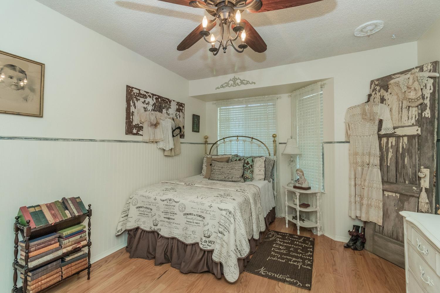 2508 Gibson Avenue Clovis, CA 93611 - Photo 22 of 33 a bedroom with a bed and a chandelier