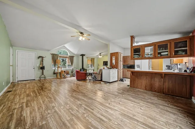 a living room with furniture and a kitchen view