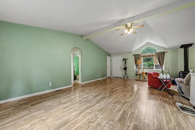 a view of a room with wooden floor and furniture