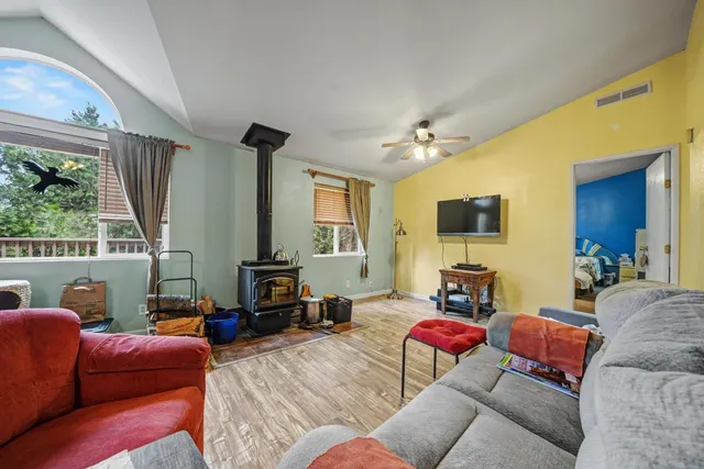 a living room with furniture a large window and a flat screen tv