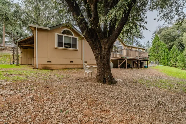 a white house that has a tree in front of it