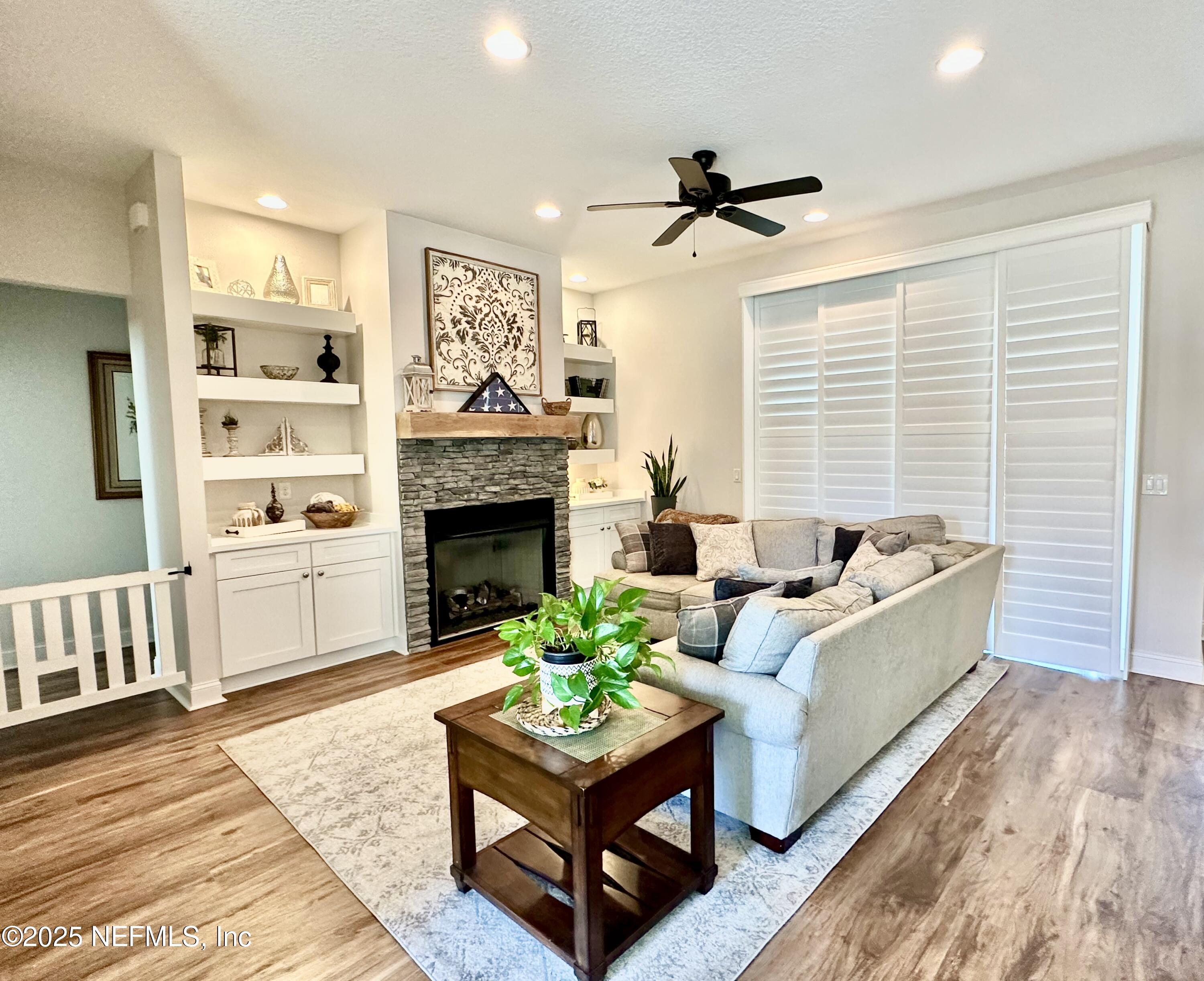 55370 Deer Run Road Callahan, FL 32011 - Photo 12 of 44 a living room with furniture fireplace and a large window