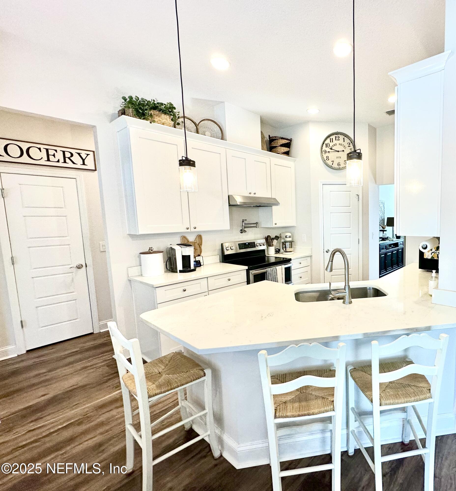 55370 Deer Run Road Callahan, FL 32011 - Photo 14 of 44 a kitchen with kitchen island a table and chairs in it