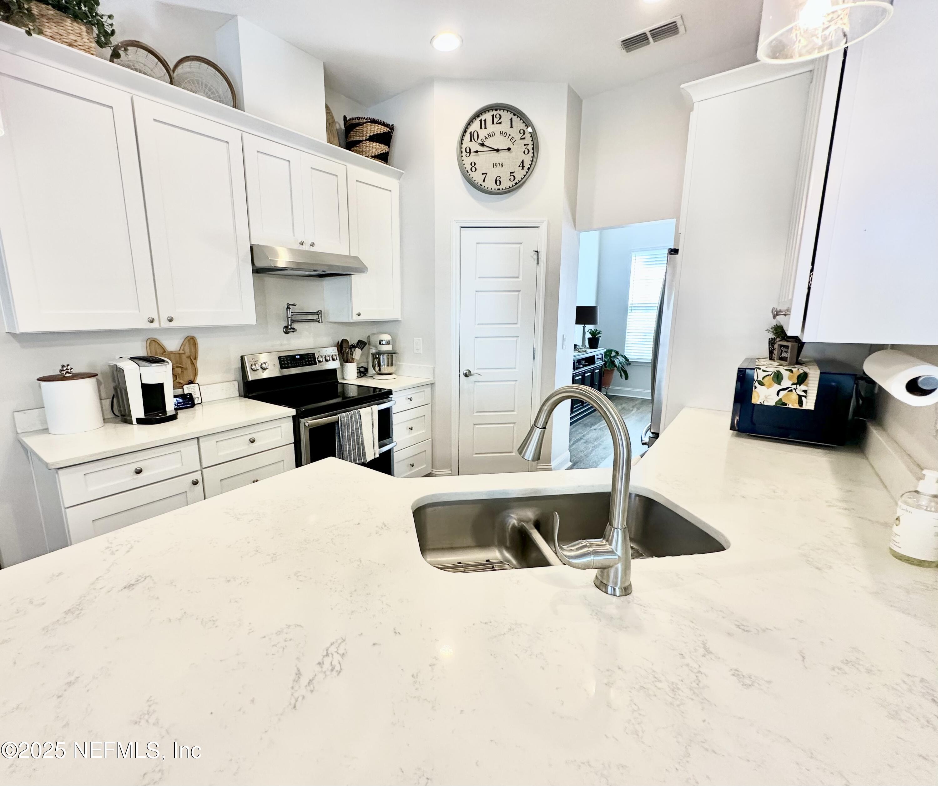 55370 Deer Run Road Callahan, FL 32011 - Photo 15 of 44 a kitchen with stainless steel appliances a sink a stove and a refrigerator