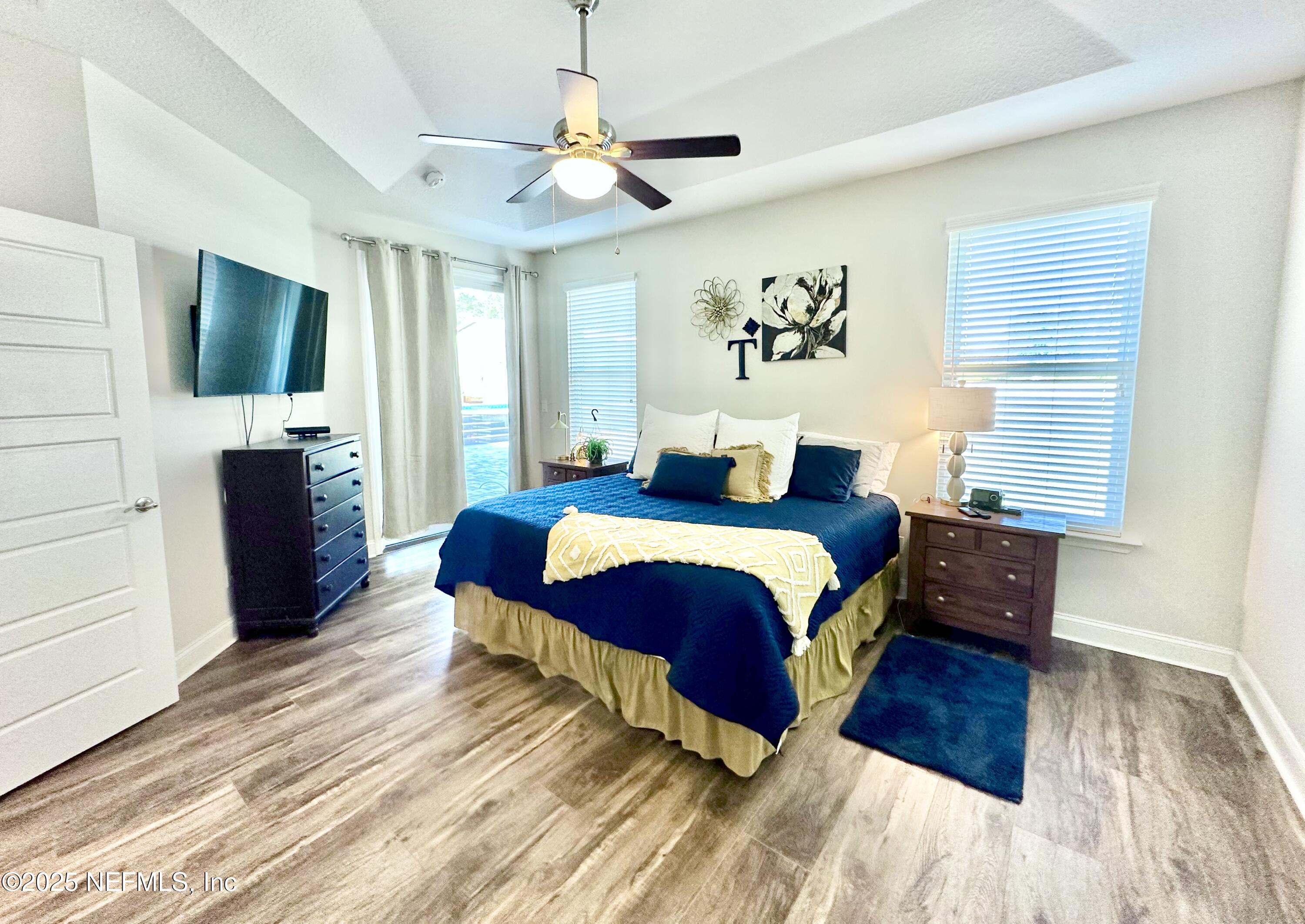 55370 Deer Run Road Callahan, FL 32011 - Photo 17 of 44 a bedroom with a bed mirror on desk and a window